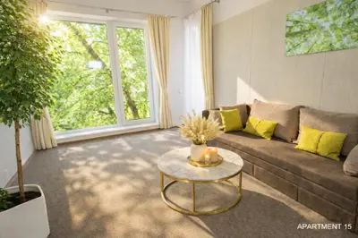 a living room with a couch and a table at HOME Apart-Hotel Vilnius in Vilnius