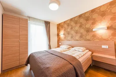 a bedroom with a bed and a window at Birutes House in Druskininkai