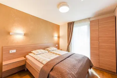 a bedroom with a bed and a window at Birutes House in Druskininkai