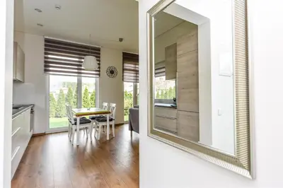 a kitchen and dining room with a large mirror at Birutes House in Druskininkai
