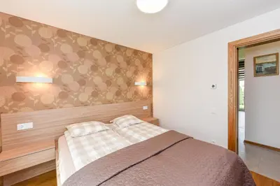 a bedroom with a bed with two pillows on it at Birutes House in Druskininkai