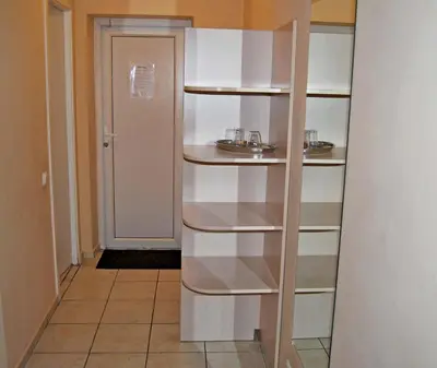 a hallway with white shelves in a room at Kambarių nuoma - Šiauliai SAURIDA in Šiauliai