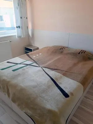 a large bed in a hospital room with avertisementvertisement at Kambarių nuoma - Šiauliai SAURIDA in Šiauliai