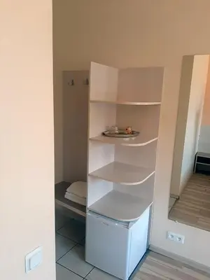 a closet with white shelves in a room at Kambarių nuoma - Šiauliai SAURIDA in Šiauliai