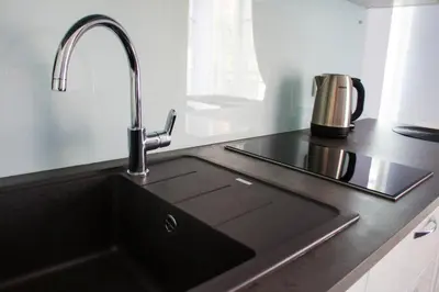 a kitchen counter with a sink at Mono Ray Apartments in Druskininkai