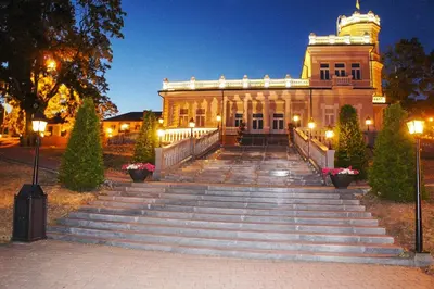 a large building with stairs in front of it at Mono Ray Apartments in Druskininkai