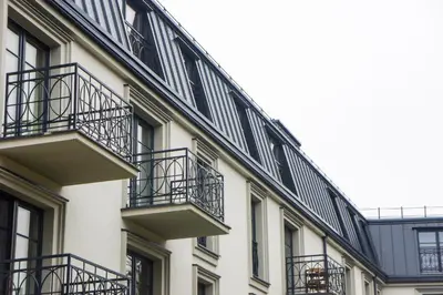 a building with balconies on the side of it at Mono Ray Apartments in Druskininkai