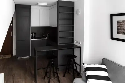 a kitchen with a counter and stools in a room at Deluxe Apartments by Hostlovers in Kaunas