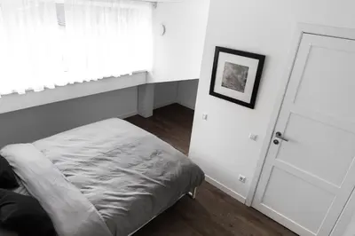 a bedroom with a bed and a white door at Deluxe Apartments by Hostlovers in Kaunas