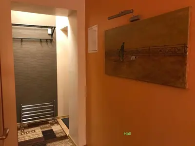 a hallway with a painting of a man and a dog at Roman in Druskininkai