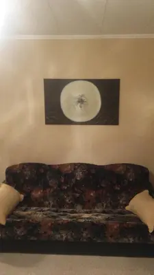 a couch in a room with a picture on the wall at Čiurlionio 83 Druskininkai in Druskininkai