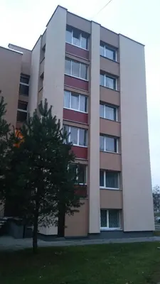an apartment building with a tree in front of it at Čiurlionio 83 Druskininkai in Druskininkai