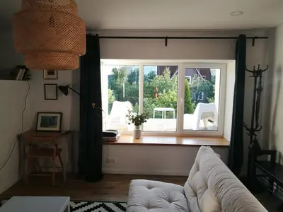 a living room with a window and a couch at Dru-Sky in Druskininkai
