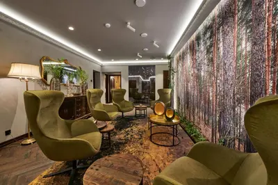 a waiting room with green chairs and a wall mural at Sofijos Rezidencija in Birštonas