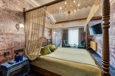 a bedroom with a bed with a canopy at Sofijos Rezidencija in Birštonas