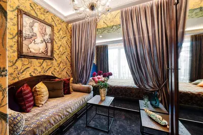 a living room with a couch and a chandelier at Sofijos Rezidencija in Birštonas