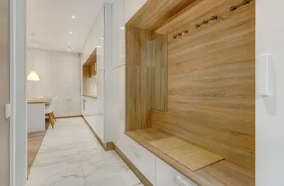 a kitchen with white cabinets and a wooden wall at HaPPy InnSide, Free Parking, Self check-in 7x24h, AC in Vilnius