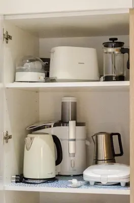 a kitchen shelf with various appliances on it at HaPPy InnSide, Free Parking, Self check-in 7x24h, AC in Vilnius
