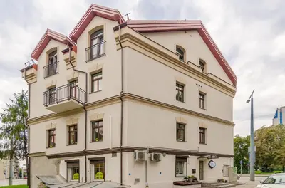 a large white building with a clock on it at HaPPy InnSide, Free Parking, Self check-in 7x24h, AC in Vilnius