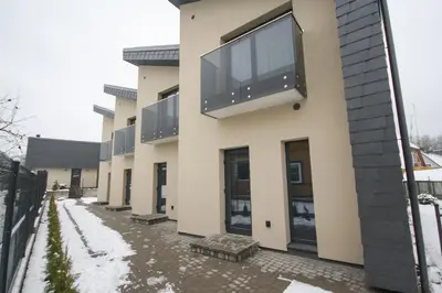 a building with a large window on the side of it at Nikolas Apartamentai - Birstono 7 in Druskininkai