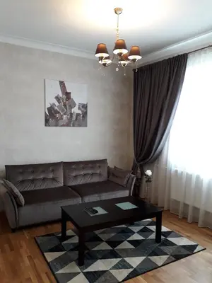 a living room with a couch and a coffee table at Mickeviciaus str apartment in Kaunas
