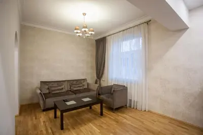 a living room with a couch and a table at Mickeviciaus str apartment in Kaunas