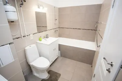 a bathroom with a toilet and a sink and a tub at Mickeviciaus str apartment in Kaunas