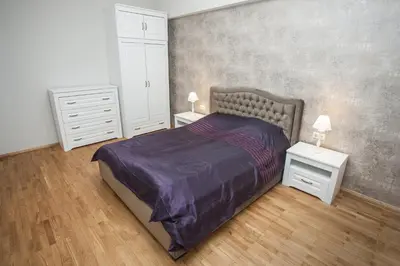 a bedroom with a bed and two night stands at Mickeviciaus str apartment in Kaunas