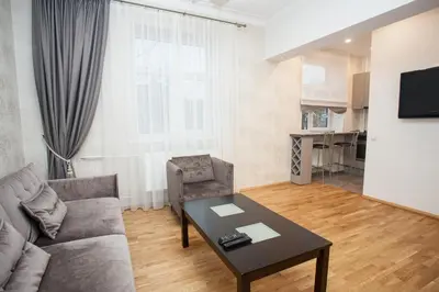 a living room with a couch and a table at Mickeviciaus str apartment in Kaunas