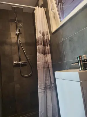 a bathroom with a shower with a shower curtain at Graikinė in Kėdainiai