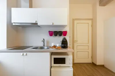 a small kitchen with a sink and a microwave at Guoda Apartments in Vilnius