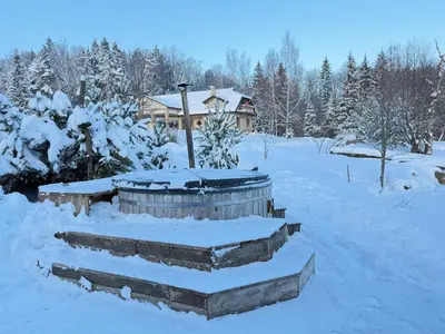 a snow covered yard with a house in the background at Prūsiškių dvaras in Sumiliszki