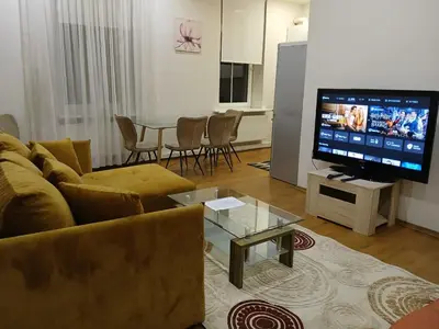 a living room with a couch and a flat screen tv at Donelaičio 42 in Kaunas