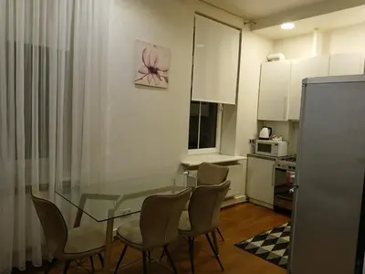 a small kitchen with a glass table and chairs at Donelaičio 42 in Kaunas