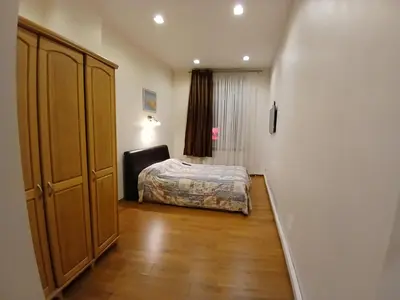 a small bedroom with a bed and a closet at Donelaičio 42 in Kaunas