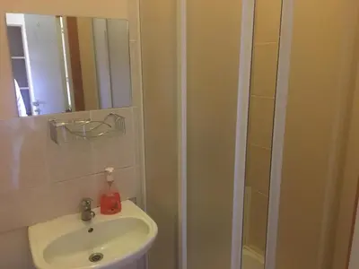 a bathroom with a sink and a mirror at Parko Vila in Druskininkai