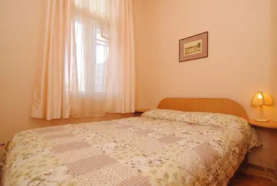 a bedroom with a bed in front of a window at Parko Vila in Druskininkai