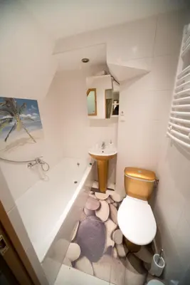 a bathroom with a toilet and a tub and a sink at Petro delux apartments in Kaunas