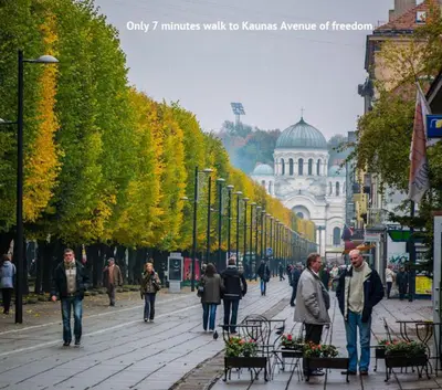 a group of people walking down a city street at Petro delux apartments in Kaunas