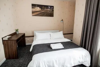 a hotel room with a bed and a desk at Hotel Tomas in Šiauliai