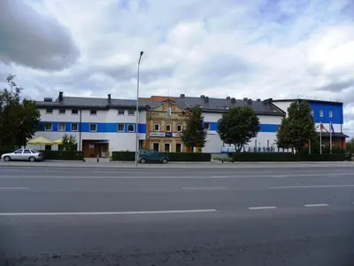 a blue and white building on the side of a street at Hotel Tomas in Šiauliai