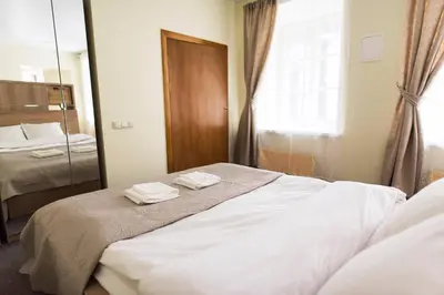 a bedroom with a bed with two towels on it at Cozy Apt in the Heart of Old Town in Vilnius