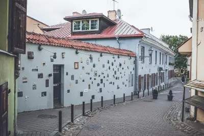 a building with a lot of pictures on the side of it at Cozy Apt in the Heart of Old Town in Vilnius