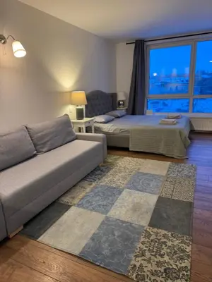 a living room with two beds and a couch at Five Star Downtown Apartment in Vilnius