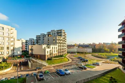 a city with cars parked in a parking lot at Five Star Downtown Apartment in Vilnius