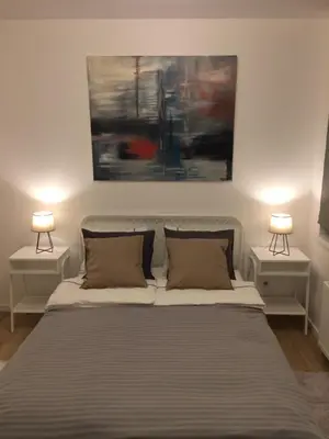 a bedroom with a large bed with two night stands at Elegant apartment close to the Old Town in Vilnius