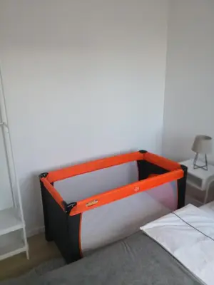 an orange and black container sitting on a bed at Elegant apartment close to the Old Town in Vilnius