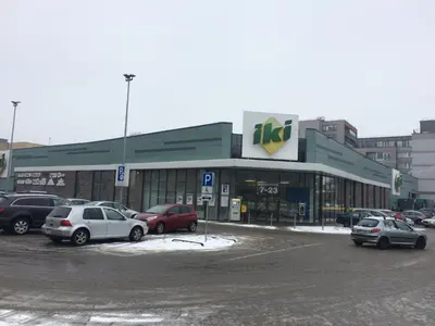 a parking lot with cars parked in front of a store at Elegant apartment close to the Old Town in Vilnius