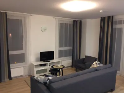 a living room with a couch and a tv at Elegant apartment close to the Old Town in Vilnius