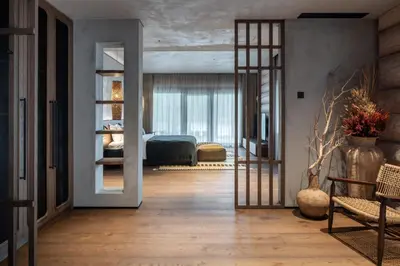 a room with a bedroom with a bed and a mirror at Esperanza Lake Resort, a Member of Design Hotels in Trakai